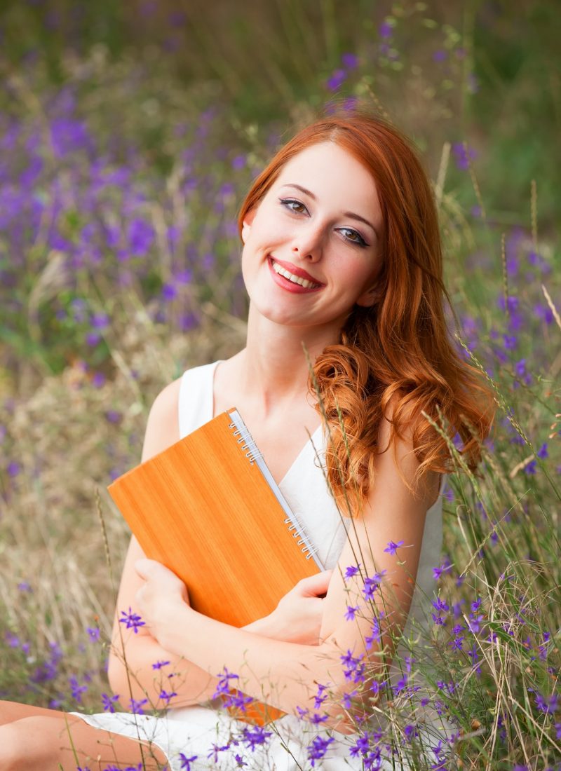 Redhead girl with note at outdoor